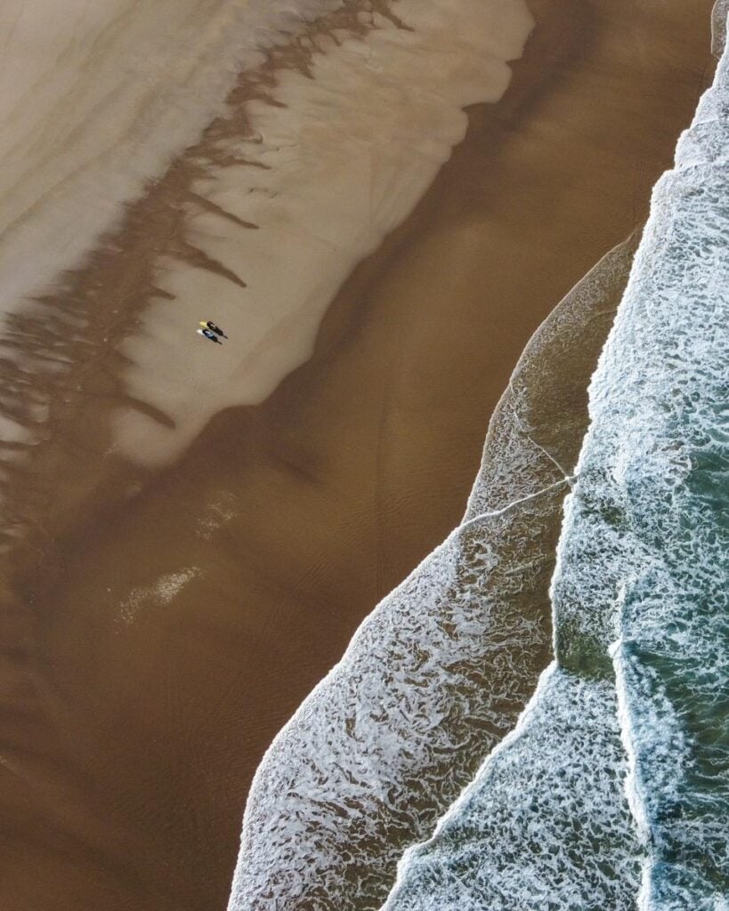 aerial view of surfers on Odeceixe Beach