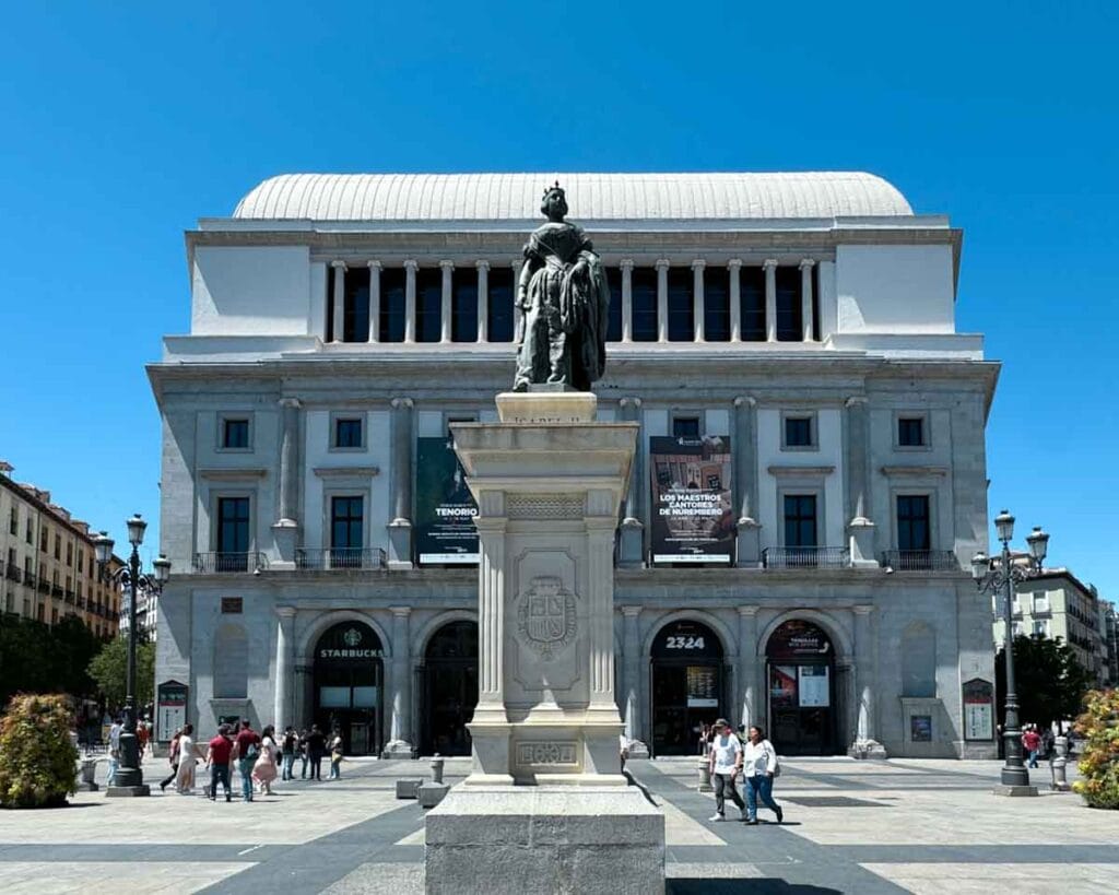statue Spanish queen Isabel II with the Royal Theatre visible behind it