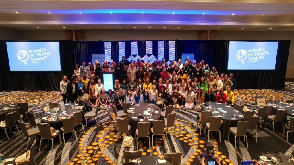large group of women posing at the women in travel summit