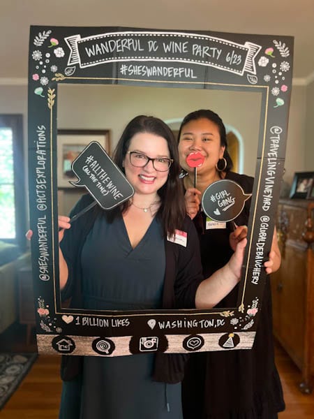 women posing for a photo inside a cardboard frame